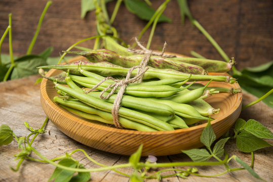 Fresh green beans on a wooden background