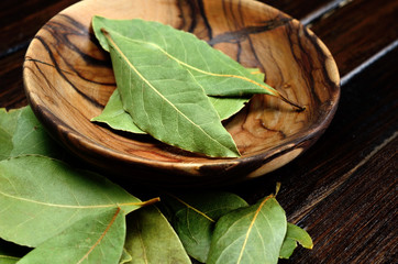 bay leaf in bowl on wooden table