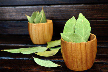 bay leaf in bowl on wooden table