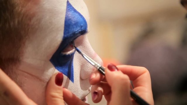 Makeup artist at work applying halloween makeup
