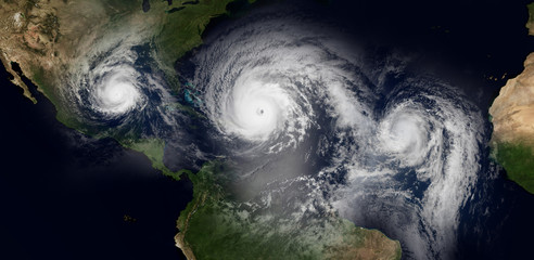 Extremely detailed and realistic high resolution 3d illustration of 3 hurricanes approaching the Caribbean Islands and Florida. Shot from Space. Elements of this image are furnished by Nasa.