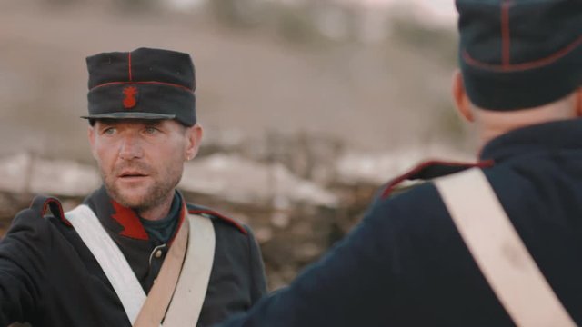 Portrait of two French soldiers set fire to cannon