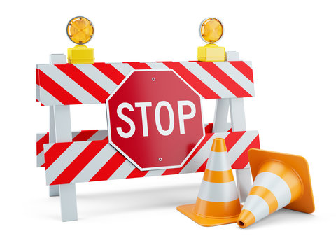 Road sign STOP on fence and traffic cones