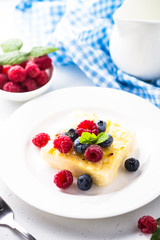 Cheesecake with fresh berries on white plate. Healthy breakfast.