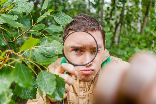 Portrait of man botanist with magnifying glass