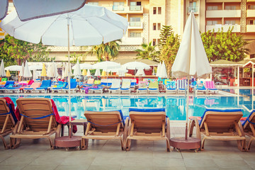 Swimming pool in spa resort . Turkey. white umbrella and chaise-longue on Hotel resort pool. Beautiful swimming pool in tropical resort.