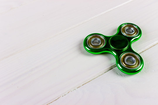 Close up shot of an green fidget spinner - Powered by Adobe