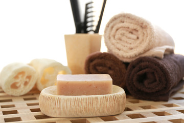 Aromatic soap and bath accessories on wicker table