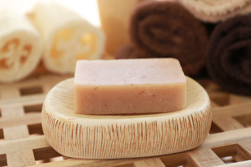 Aromatic soap and bath accessories on wicker table