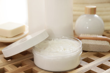 Composition with bath cosmetics and accessories on wicker table