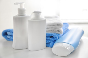 Composition with bath cosmetics and towels on table