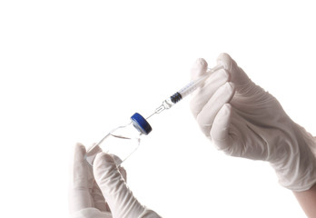 Doctor with syringe and medicine on white background