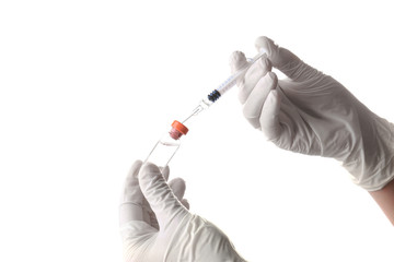 Doctor with syringe and medicine on white background