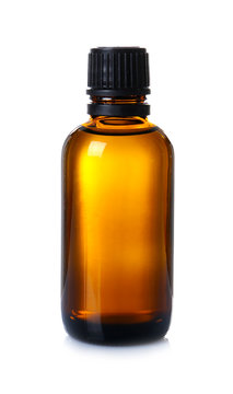 Glass bottle with essential cinnamon oil on white background