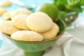 Bowl with homemade lemon cookies on table, closeup