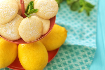 Dessert stand with homemade lemon cookies and fresh fruit on table, closeup