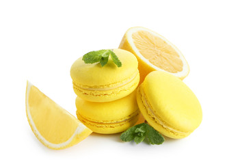 Lemon macarons with sliced fruit and mint leaves on white background