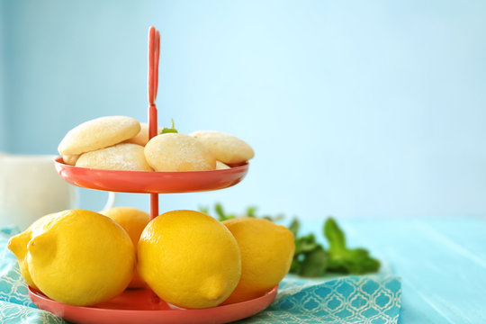 Dessert stand with homemade lemon cookies and fresh fruit on table