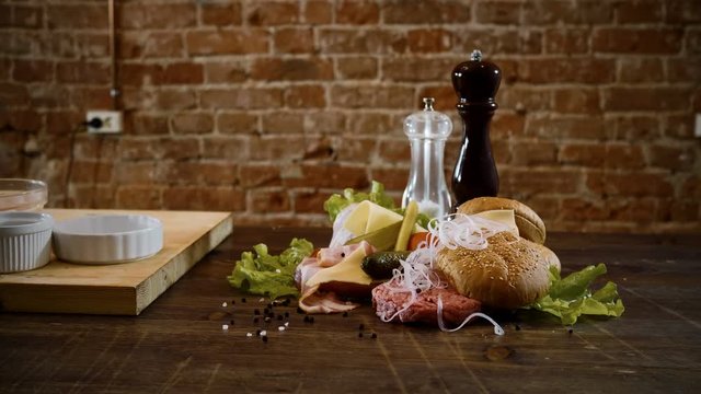 Cooking burger. Panorama of foodstuffs prepared for cooking a hamburger in a kitchen. 4K
