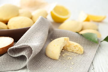 Broken homemade cookie with lemon flavor on napkin, closeup