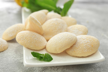 Plate with homemade lemon cookies on table