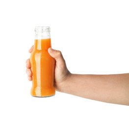 Woman holding bottle of fresh carrot juice on white background