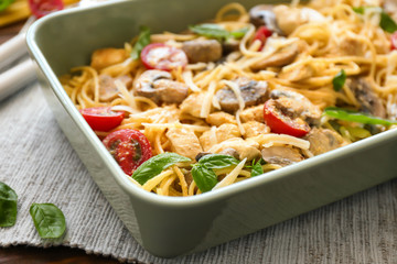 Delicious roasted turkey tetrazzini in baking dish on table
