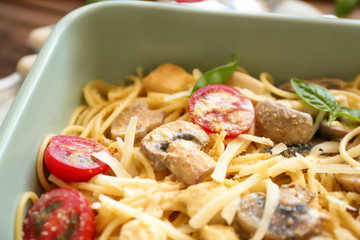 Delicious roasted turkey tetrazzini in baking dish, close up