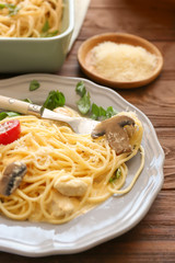 Plate with delicious roasted turkey tetrazzini on table