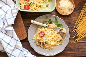 Plate with delicious roasted turkey tetrazzini on table