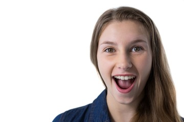 Obraz na płótnie Canvas Excited teenage girl standing against white background