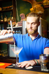 The barman prepares a classy alcoholic cocktail