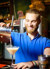 The barman pours a cool alcoholic cocktail