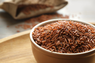 Bowl with jasmine brown rice on table