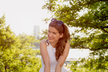 Naklejka na ściany i meble Attractive smiling woman posing outdoors.