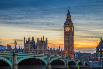 London, England - The iconic Big Ben, Houses of Parliamen and Westminster bridge at sunset with beautiful sky