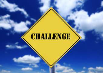 Yellow road sign with cloudscape with challenge text