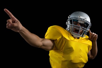 American football player cheering with both his hands raised