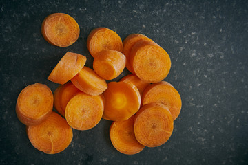 Chopped and Sliced Carrot on a dark Kitchen Worktop