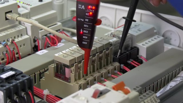 Check microcontroller control element contacts voltage indicator in factory. Handwork processes. Manufactory energy measurement accuracy technology. Computer devices.