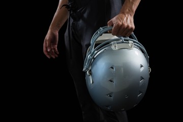 American football player holding a head gear 