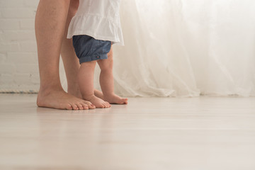 A Baby and Her Mother's Feet