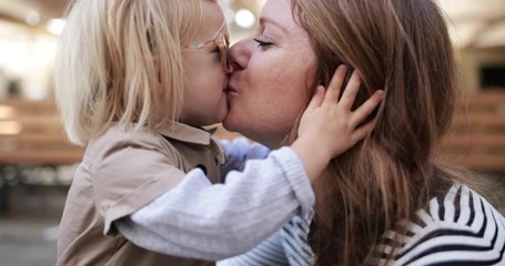 Child kissing mother