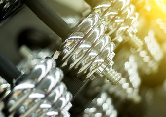 Dumbbells in gym closeup photo. Shiny metallic dumbbells or barbell weights
