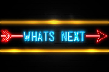 Whats Next  - fluorescent Neon Sign on brickwall Front view