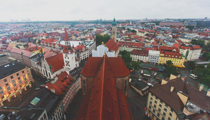 Fototapeta na wymiar Beautiful super wide-angle sunny aerial view of Munich, Bayern, Bavaria, Germany with skyline and scenery beyond the city, seen from the observation deck of St. Peter Church