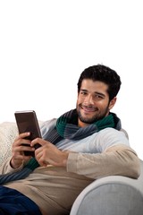 Smiling man using digital tablet against white background