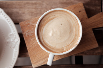 A cup of coffee put on wooden board