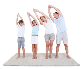 Fototapeta na wymiar Family Doing Stretching Exercises On The Carpet