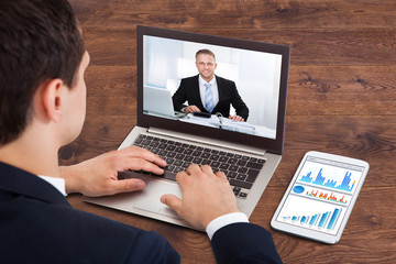 Businessperson Video Conferencing With Male Colleague